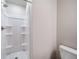 Bright bathroom featuring a pristine white shower and toilet with a minimalist aesthetic at 46558 Avery Ln, Bennett, CO 80102