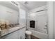 Bright bathroom with granite countertop, framed mirror, and shower over tub with sliding glass doors at 46558 Avery Ln, Bennett, CO 80102