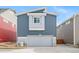 Modern two-story home with two-car garage, light gray siding, and a concrete driveway at 46558 Avery Ln, Bennett, CO 80102