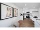 Tastefully designed living room showcasing modern decor, framed wall art and an open view of the adjacent kitchen at 46558 Avery Ln, Bennett, CO 80102