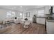 Bright living space showcasing an open-concept design with a kitchen, dining area, and natural light at 46558 Avery Ln, Bennett, CO 80102
