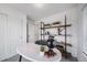 Bright office featuring an accent shelving unit, white walls, and modern decor at 46558 Avery Ln, Bennett, CO 80102