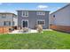 Expansive backyard with a well-maintained lawn, patio with outdoor furniture, and a cozy egg chair setup at 635 Silver Rock Trl, Castle Rock, CO 80104