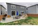 Spacious backyard with seating on a concrete patio, an umbrella, and a grill at 635 Silver Rock Trl, Castle Rock, CO 80104