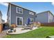 Spacious backyard featuring a patio area, lush green lawn, and comfortable egg chairs, ideal for outdoor living at 635 Silver Rock Trl, Castle Rock, CO 80104