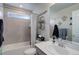 Neutral toned bathroom featuring a shower-tub combo and decor at 635 Silver Rock Trl, Castle Rock, CO 80104