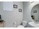 Well-lit half bathroom with a modern sink, a toilet, and neutral wall decor at 635 Silver Rock Trl, Castle Rock, CO 80104