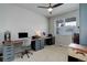 Comfortable bedroom with an expansive desk, a ceiling fan, and natural light at 635 Silver Rock Trl, Castle Rock, CO 80104