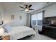 This bedroom features a ceiling fan, a window with blinds, and comfy-looking bedding at 635 Silver Rock Trl, Castle Rock, CO 80104