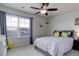 Bright bedroom features a ceiling fan and a window providing ample natural light at 635 Silver Rock Trl, Castle Rock, CO 80104