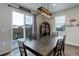 Cozy dining area with a large wooden table, modern light fixture, and access to the backyard at 635 Silver Rock Trl, Castle Rock, CO 80104