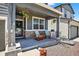 Charming front porch featuring decorative chairs, hanging flower baskets, and a welcoming entrance at 635 Silver Rock Trl, Castle Rock, CO 80104