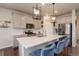 Stylish kitchen featuring a large island, stainless appliances, and modern pendant lighting at 635 Silver Rock Trl, Castle Rock, CO 80104