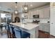 Bright and airy kitchen with white quartz countertops, stainless steel appliances, and pendant lighting at 635 Silver Rock Trl, Castle Rock, CO 80104