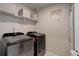 Modern laundry room with front-load washer and dryer, plus storage at 635 Silver Rock Trl, Castle Rock, CO 80104