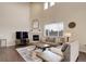 Spacious living room with tall ceilings, a fireplace, a large window, and comfortable seating at 635 Silver Rock Trl, Castle Rock, CO 80104