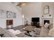Bright living room features high ceilings, fireplace, and hardwood floors at 635 Silver Rock Trl, Castle Rock, CO 80104