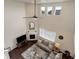 Aerial view of living room features high ceilings, fireplace, hardwood floors and comfortable furniture at 635 Silver Rock Trl, Castle Rock, CO 80104