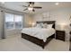 Comfortable main bedroom boasts a spacious layout, large windows and neutral decor at 635 Silver Rock Trl, Castle Rock, CO 80104