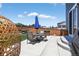 Outdoor patio area with patio furniture, umbrella, and wicker chair, perfect for relaxing and entertaining at 635 Silver Rock Trl, Castle Rock, CO 80104