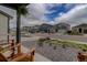 A cozy front porch with chairs overlooks a quiet street in a residential neighborhood at 635 Silver Rock Trl, Castle Rock, CO 80104