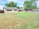 Large fenced backyard featuring a shed, mature trees, and patio for entertaining at 245 Miller Ave, Brighton, CO 80601
