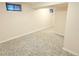 Finished basement featuring neutral walls, carpet and natural light from two windows at 245 Miller Ave, Brighton, CO 80601