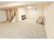 Spacious finished basement with neutral carpet and a seating area at 245 Miller Ave, Brighton, CO 80601