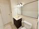 Clean bathroom with marble-look vanity, large mirror, and tile floor at 245 Miller Ave, Brighton, CO 80601