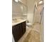 Clean bathroom with marble-look vanity, large mirror, and shower at 245 Miller Ave, Brighton, CO 80601