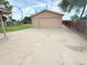 Detached garage with a large concrete driveway and side door, plus fenced yard at 245 Miller Ave, Brighton, CO 80601