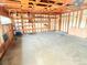 Spacious garage interior with built-in shelving and concrete floor, ready for storage at 245 Miller Ave, Brighton, CO 80601