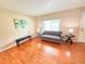 Bright living room with gleaming hardwood floors and comfortable seating at 245 Miller Ave, Brighton, CO 80601