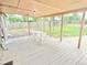 Covered patio with a white table and chairs, great for outdoor entertaining at 245 Miller Ave, Brighton, CO 80601