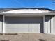 Attached garage with gray door and snowy roof at 7585 S Rosemary Cir, Centennial, CO 80112