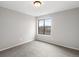 Bright bedroom with neutral walls, carpet, and a window at 12565 Sheridan Blvd # 208, Broomfield, CO 80020