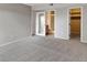 Bedroom with mirrored closet doors and access to bathroom at 12565 Sheridan Blvd # 208, Broomfield, CO 80020