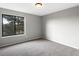 Simple bedroom with neutral gray walls, carpet, and a window at 12565 Sheridan Blvd # 208, Broomfield, CO 80020