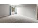 Spacious carpeted bedroom with a window and neutral wall colors at 12565 Sheridan Blvd # 208, Broomfield, CO 80020