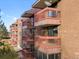 Brick building with multiple balconies and satellite dishes at 12565 Sheridan Blvd # 208, Broomfield, CO 80020