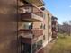 Brick building with multiple balconies and satellite dishes at 12565 Sheridan Blvd # 208, Broomfield, CO 80020