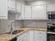 Renovated kitchen with granite counters and stainless appliances at 12565 Sheridan Blvd # 208, Broomfield, CO 80020