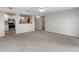 Bright living room with carpet and an open concept kitchen at 12565 Sheridan Blvd # 208, Broomfield, CO 80020