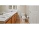 Bathroom with double sinks, wood cabinets and toilet, creating a functional space at 5726 N Genoa Way # 301, Aurora, CO 80019