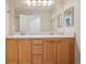 Bathroom with dual sinks, vanity, and large mirror, creating a functional space at 5726 N Genoa Way # 301, Aurora, CO 80019