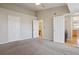 Spacious bedroom with ceiling fan and featuring access to a bathroom and laundry area at 5726 N Genoa Way # 301, Aurora, CO 80019