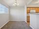 Dining room filled with natural light with gray carpet and stylish chandelier at 5726 N Genoa Way # 301, Aurora, CO 80019