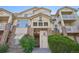 Inviting multi-story condo with brick accents, private balconies, and lush landscaping at 5726 N Genoa Way # 301, Aurora, CO 80019