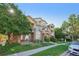 Attractive townhouse with brick and siding exterior, lush landscaping, and private balconies at 5726 N Genoa Way # 301, Aurora, CO 80019