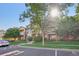 A multi-story condo boasts curb appeal with balconies, brick accents, lush landscaping and a sunny, welcoming atmosphere at 5726 N Genoa Way # 301, Aurora, CO 80019